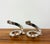 A sculptural pair of vintage candle holders crafted in polished chrome with dramatic sweeping spiral forms. Each features...