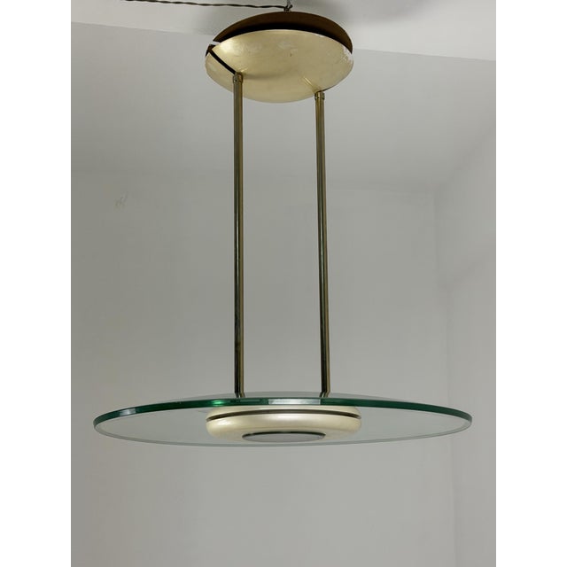 Pendant lamp in the style of Max Ingrand for Fontana Arte, made of brass and Nile green Murano glass. Halogen light....