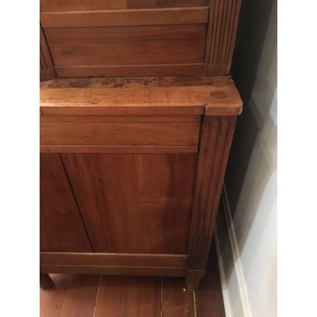 A handsome French provincial buffet deux corps, the stepped top with tall doors flanked by fluted columns and over a...