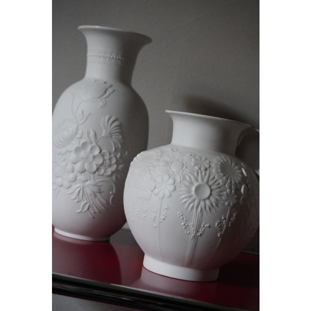 Set of 3 vases in opaque white bisque porcelain, made by Kaiser, Germany, with a floral design from the 1960s. In perfect...