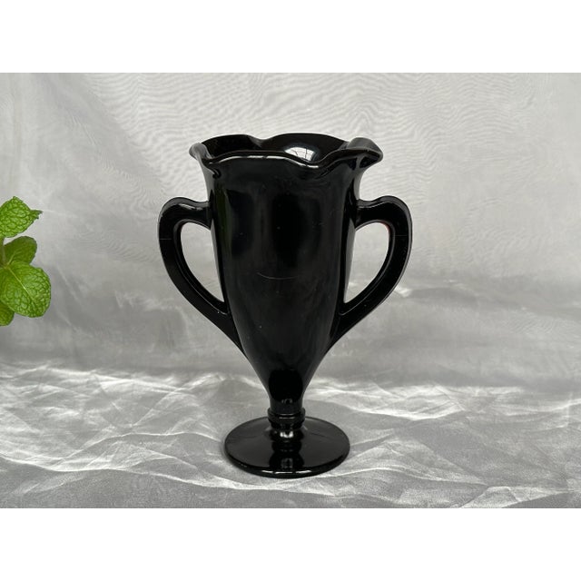 Fill this vintage black amethyst glass with flowers and use it as a dramatic decor accent on a living room coffee table,...