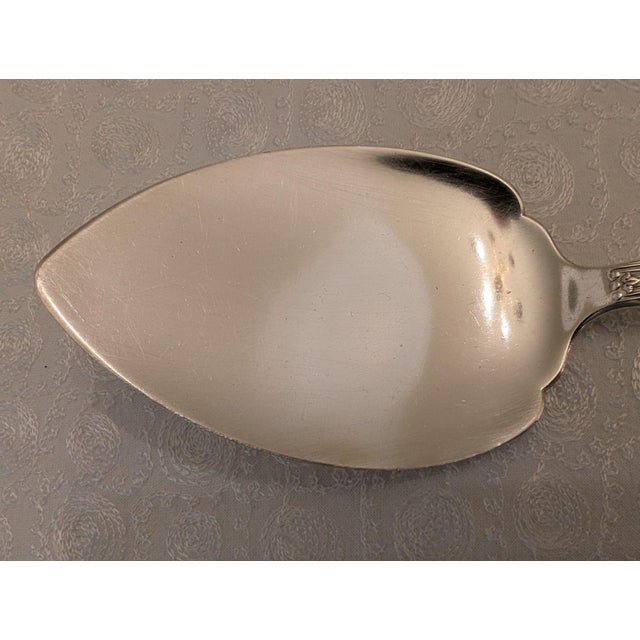 A large, solid sterling silver one-piece pie server of substantial weight in the traditional Kings pattern by Theodore B....