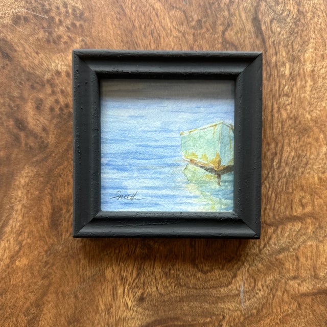A quiet, minimalist seascape in soft blues and greens, this small framed watercolor captures the gentle calm of water...