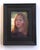 The artwork depicts a young girl with flowing hair, her expression revealing a moment of contemplation or introspection....