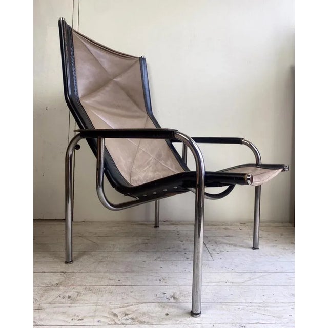 This Lounge chair by Hans Eichenberger has a high quality chrome plated tubular base and a brown leather adjustable seat...