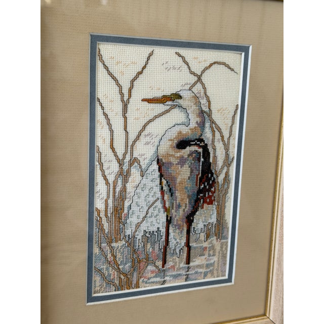 Charming vintage needlepoint textile featuring a graceful coastal egret standing among marsh reeds. The detailed hand-...