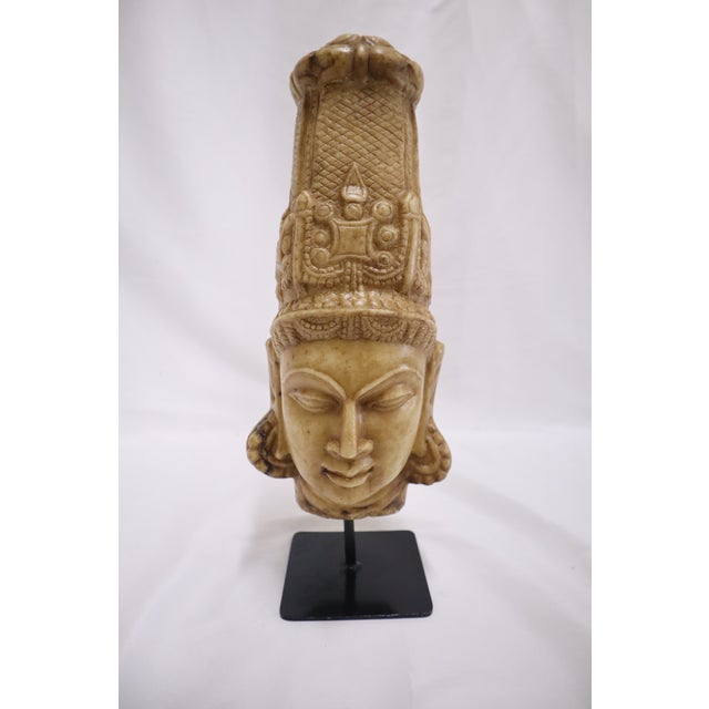 Beautiful hand carved stone head of an Indian deity, potentially depicting one of the principal Hindu gods Shiva or...