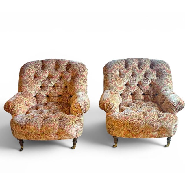 We are pleased to present a pair of tufted club chairs with a soft paisley fabric. These are in the style of George Smith...