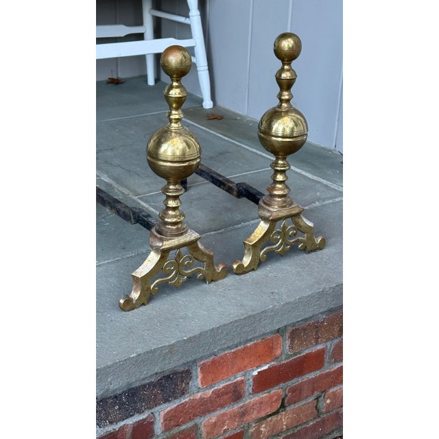 Handsome ball top brass andirons with Fleur de Lis feet. Very hard to come by these days. The brass was lacquered at some...