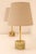 A refined pair of small italian table lamps from the 1960s, crafted in onyx and brass. these elegant lamps embody the...