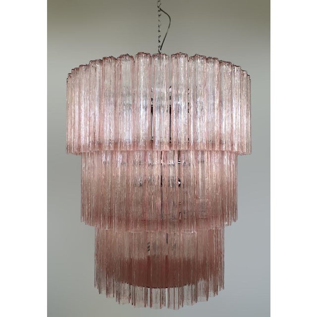 Italian chandelier shown in pink hand blown Murano Tronchi glasses arranged in 3 tiers, mounted on polished chrome finish...