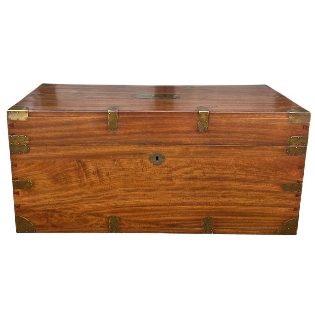 Circa early 1900s England. A handsome and generously proportioned camphor wood traveling trunk, brass bound and fitted...