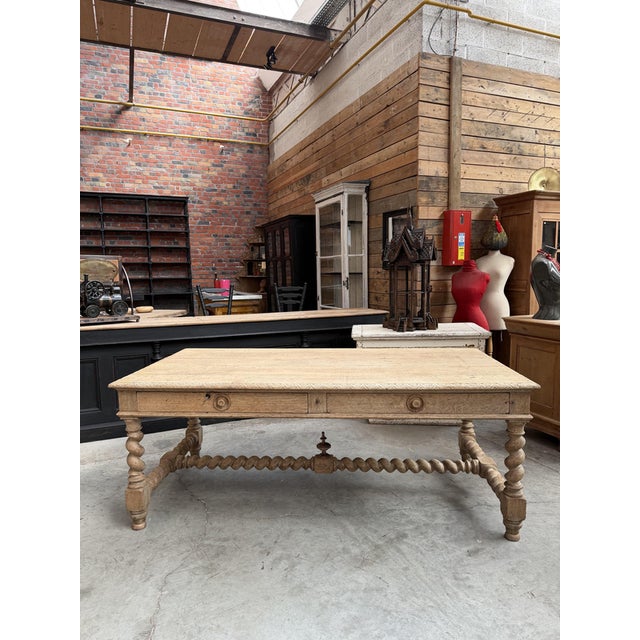 This imposing solid oak castle table has been fully restored. It comprises a wide top with a carved edge, two large...