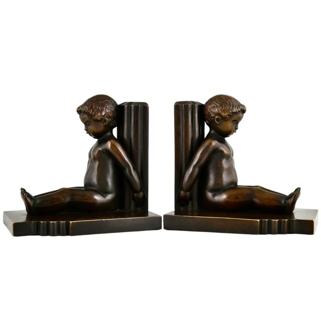 Art Deco bronze bookends seated children signed by Paul Silvestre with Susse Freres founders' signature. Bronze with brown...