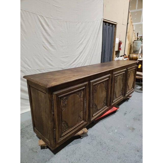 A monumental late 18th century French provincial oak enfilade, circa 1780, of exceptional scale and presence. Measuring an...