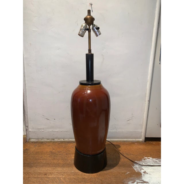 Vintage brown ceramic jar table lamp with solid black wood base formally used in a private club in downtown Los Angeles a...