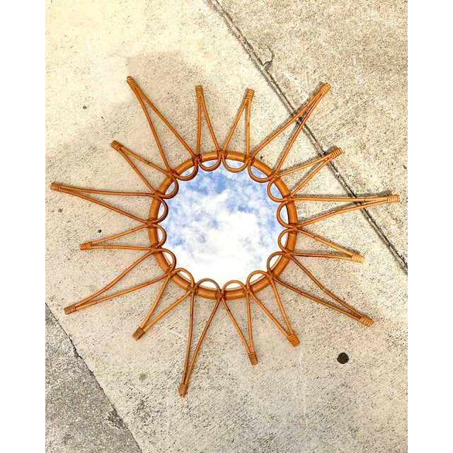 This exquisite vintage Italian sunburst mirror is a masterclass in organic modernism and artisanal craftsmanship....