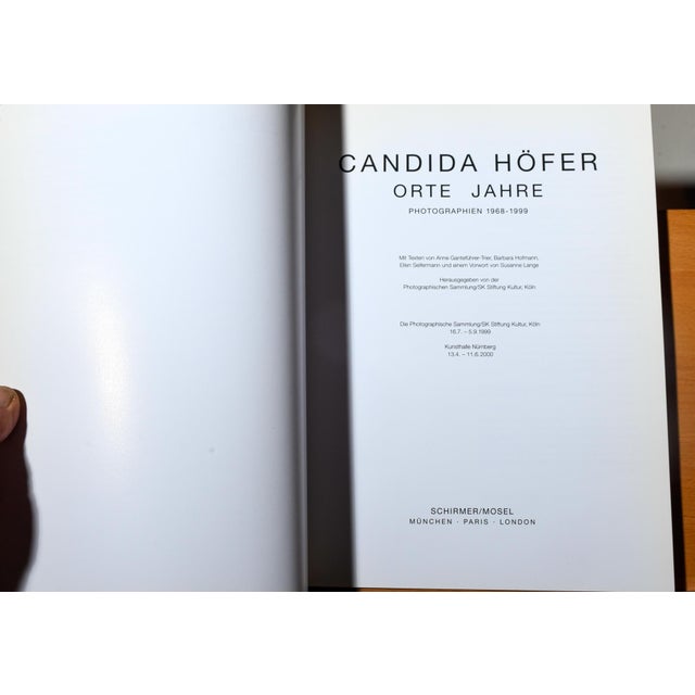 Scarce first edition of this important retrospective catalogue documenting Candida Höfer's photographic work across three...