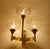 large vintage wall light featuring a bronze and brass structure with 3 spokes and light amber tint glass globe shades...
