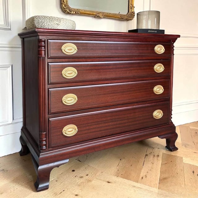 A timeless Federal style mahogany dresser featuring elegant fluted corner columns, classic replica Hepplewhite pulls, and...