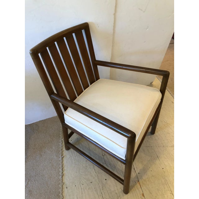 Sleek and classic Robsjohn Gibbings mid century modern walnut arm chair with new white duck comfy upholstered seat. Made...