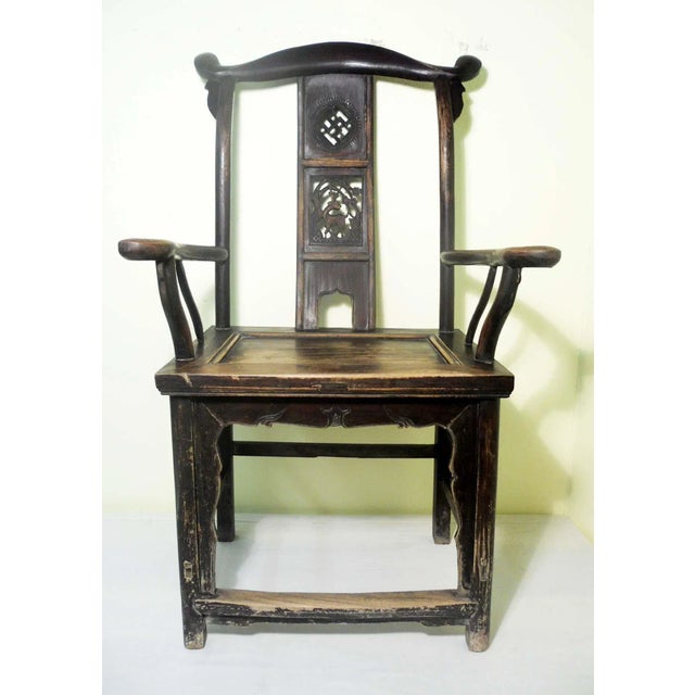 This style of chair is known as "official's hat chair" because the projections over the rear stiles resemble the knobs on...