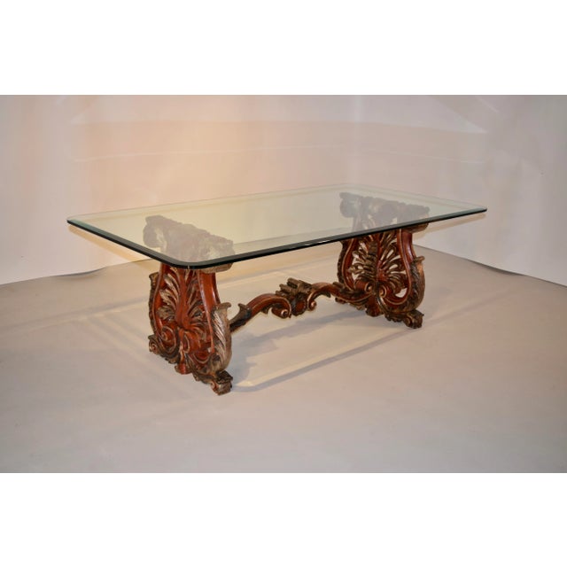 19th century hand-carved and painted wooden coffee table from Italy. The end supports are trestle shaped and are finely...