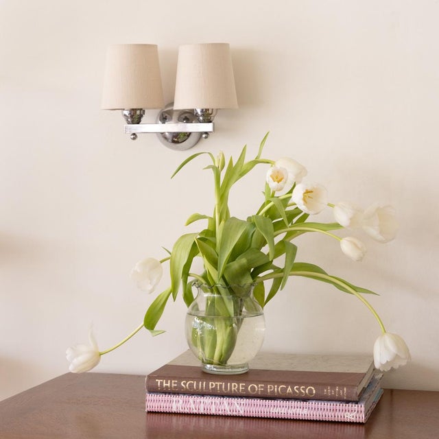 Incredible pair of petite two arm sconces from France, 1930's. Great Art Deco style in chrome with two arms on straight...