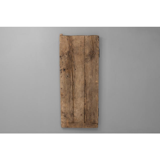 Three plank oak door with original iron hinges. New forged wall mounts. France circa 1800.