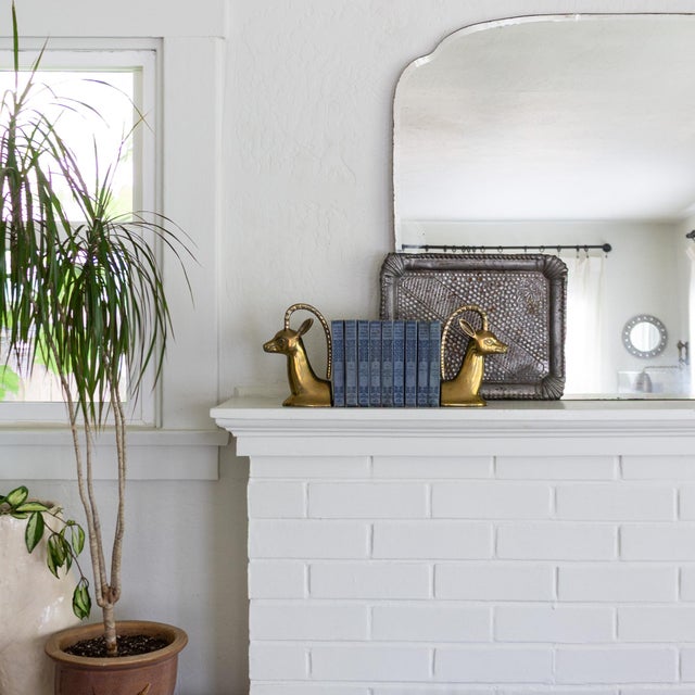 A vintage mid-century pair of ibex brass bookends.