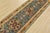 A traditional tribal Heriz runner, hand-knotted with fine wool on a cotton foundation. This rug features geometric...