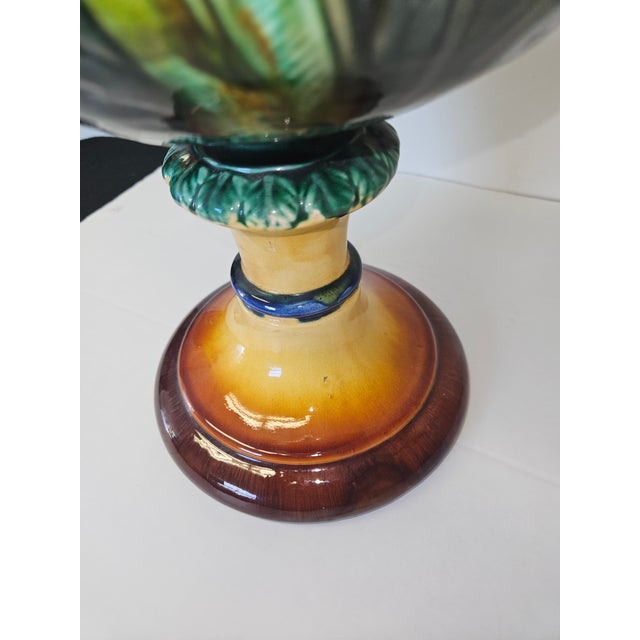 Wonderful Classical Style and stately Majolica urn with cherub and floral surround in fabulous colored glazes. The Two...