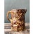 Crafted from ceramic, this vintage spatterware pitcher embodies rustic charm with its striking mottled glaze. The surface...