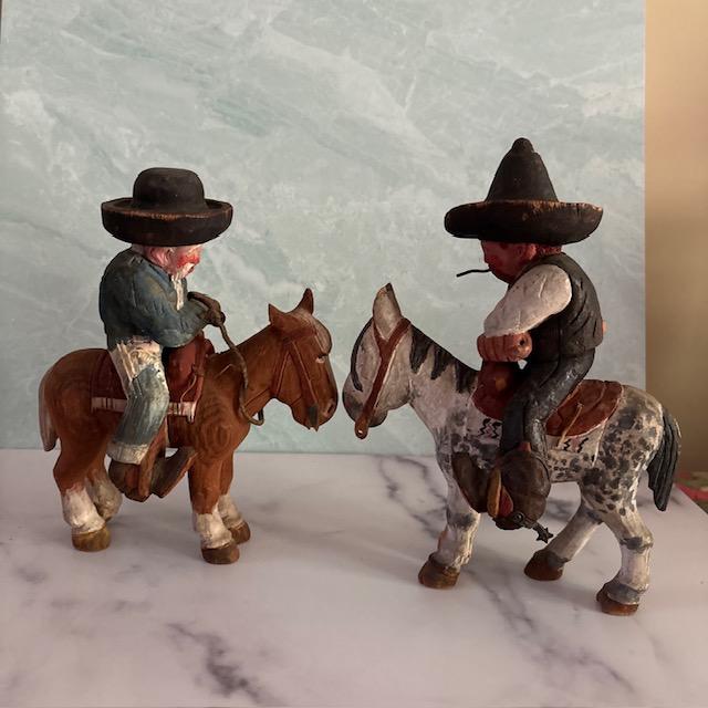 Extraordinary early 20th century folk art of two Old West cowboys on their horses. Hand-carved and hand-painted. Cowboy...