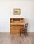An English country pine bureau in the Georgian tradition, with the classic slant-front form that opens onto a working...