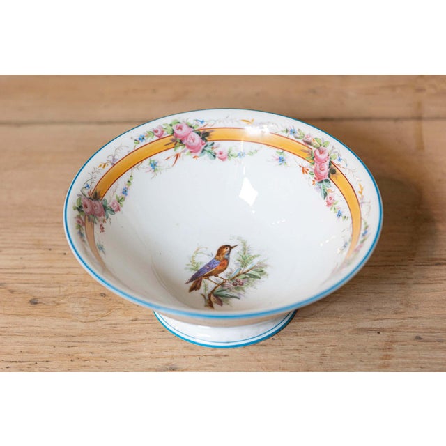 This 19th-century French porcelain piece is a finely crafted example of the decorative artistry of the time, likely...