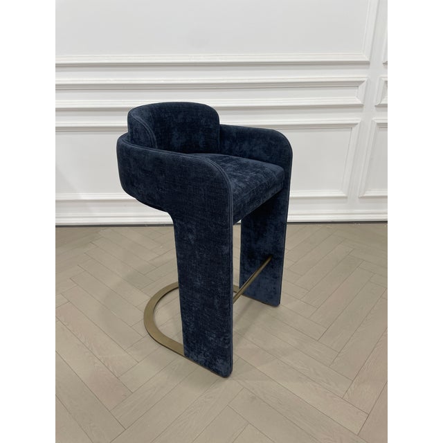 Elevate your bar game with our Indigo Upholstered Bar Chair. Sink into the luxurious blue velvet upholstery while enjoying...