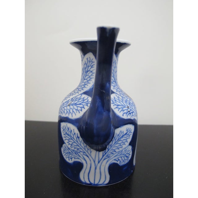 Chinese or Japanese blue and white porcelain cruet with cabbage design. Measures 4 1/4" tall x 4" x 2 3/4" Spout has...