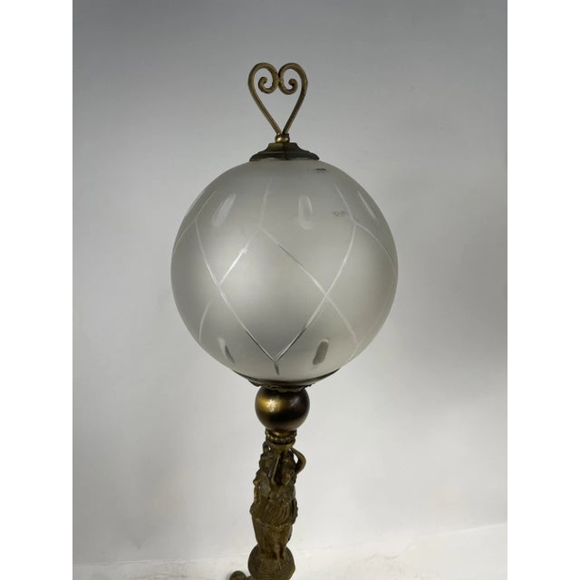 Beautiful Art Nouveau style table lamp, 1920s. Made of bronze with glass globe with carved decorations. Excellent...