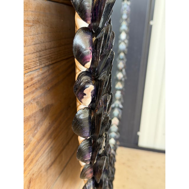 A striking handmade coastal mirror crafted from hand-picked mussel shells gathered along the coast of Maine. The shells...