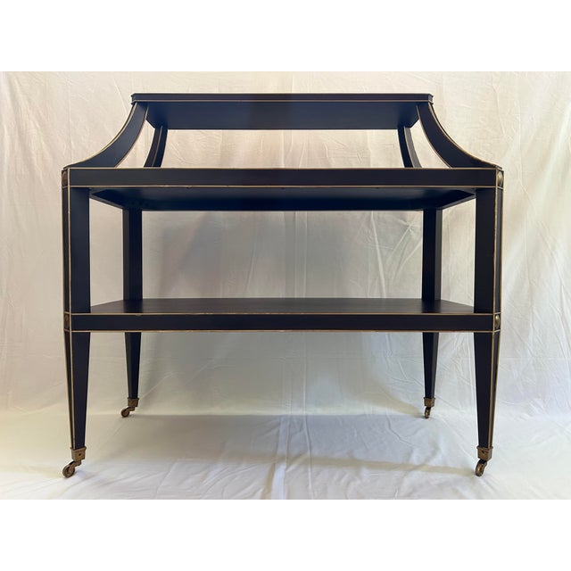 Offered is a neoclassical style console, inspired by 1940's French salon étagères. Maker: Baker Furniture Company....