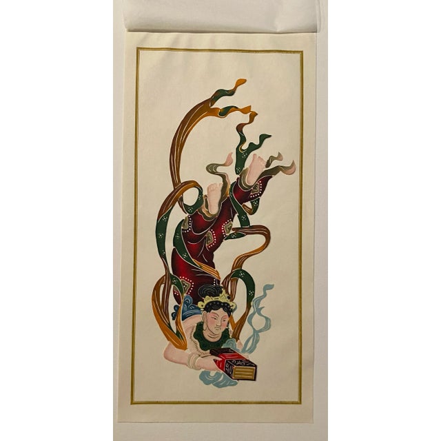 Chinese cut out of a deity made of painted and cut thin paper. The cut out come with between tissue paper and a backing...