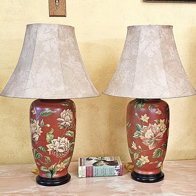 Elegant pair of vintage Chinoiserie ceramic ginger jar table lamps with rich burgundy-red backgrounds and beautifully...