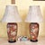 Elegant pair of vintage Chinoiserie ceramic ginger jar table lamps with rich burgundy-red backgrounds and beautifully...