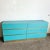 Add a bold statement to your space with this Postmodern Teal Laminate Dresser, featuring six spacious drawers and sleek...