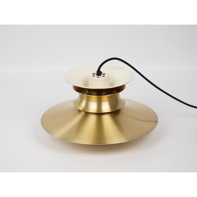 Lyskaer aluminum lamp from the 1970s. The lamp's form was designed based on the principle of a reflective system that...