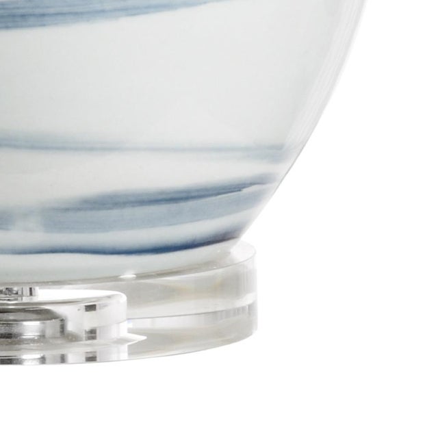 Add movement and beauty to your home with isadora lamp. Featuring a double gourd shape, this hand painted white glazed...