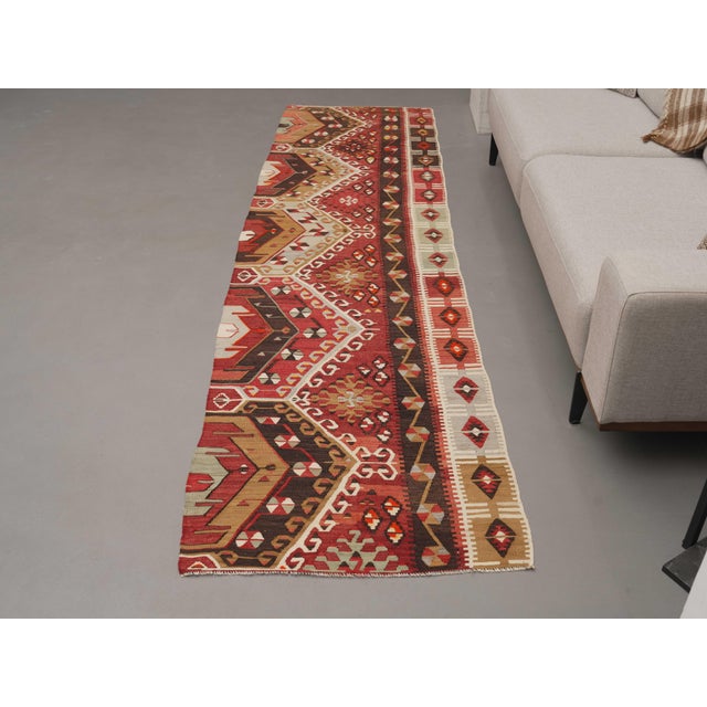 Vintage Hand-Knotted runner rug is a semi-antique vintage area rug. The '70s Eastern region of Anatolia's unique rug is...