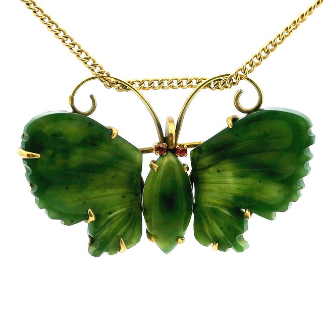 A beautiful pair of vintage butterfly brooches crafted in 14 karat yellow gold and set with finely carved green jade...