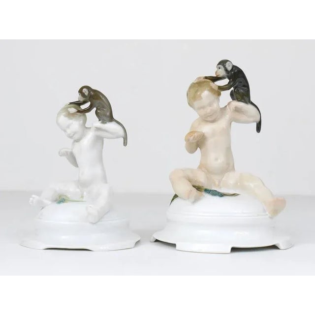 An unusual porcelain figurine displaying a putto being deloused by a monkey. This figurine was created by the German...